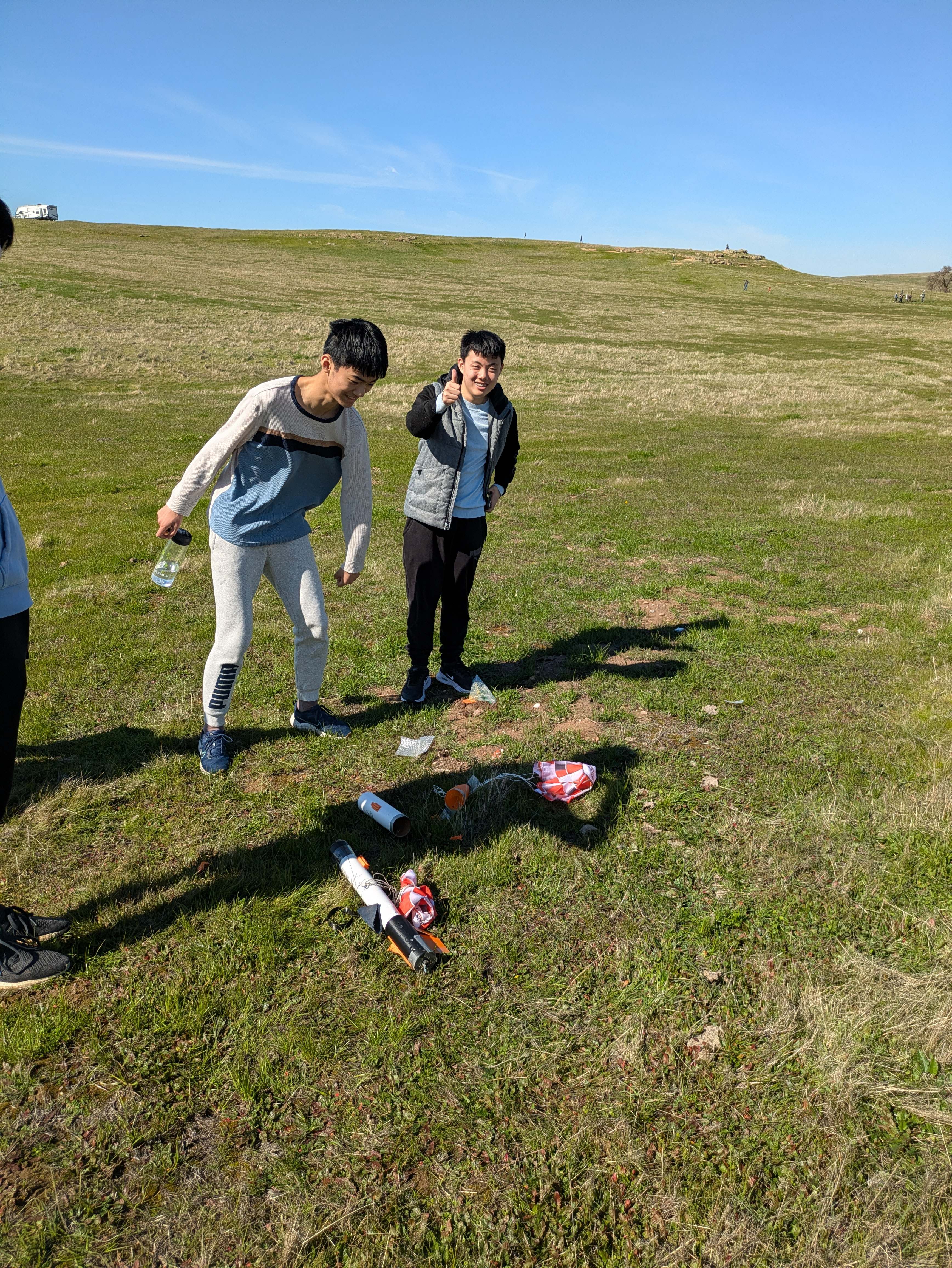 Team members with rockets and equipment on the ground